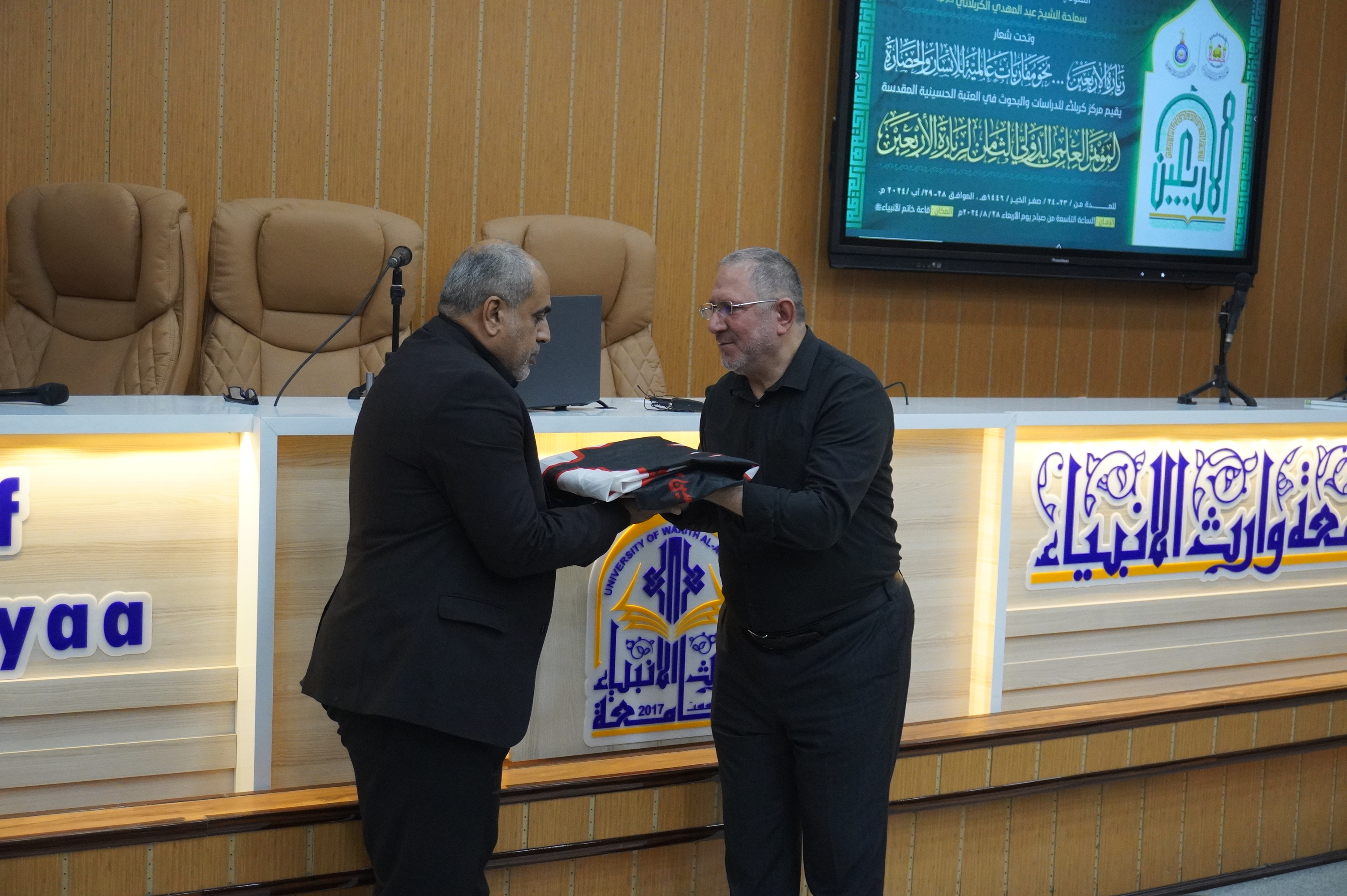 Handing over the banner of the 9th International Scientific Conference to the University of Baghdad